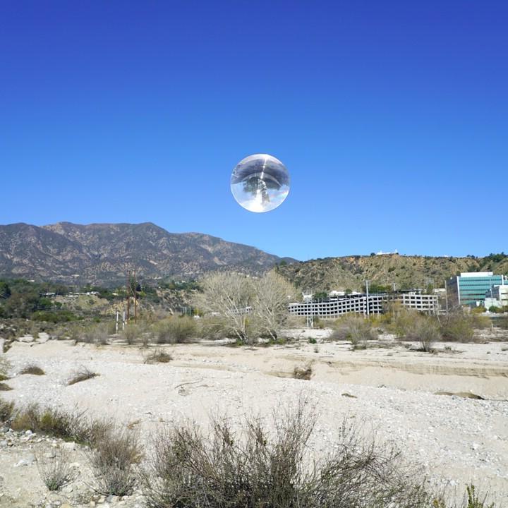 sphere over desert landscape